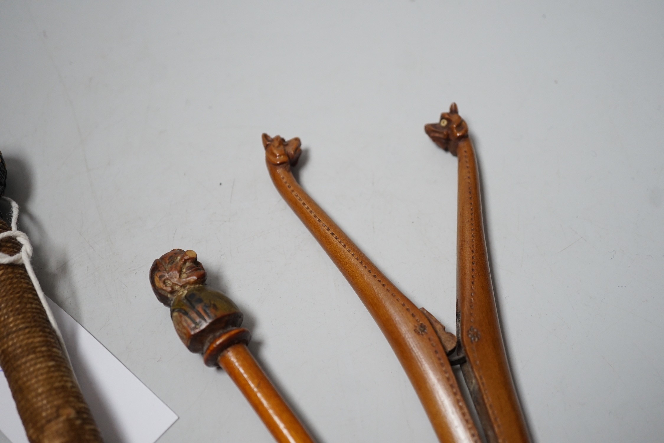 A pair of novelty treen glove-stretchers, 19cm, a similar pipe, a mauchline box and a 19th century beater